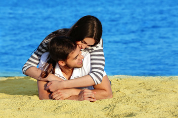 Young couple lying on beach