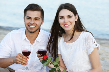 Romantic date of young couple on beach