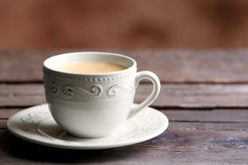 Cup of coffee on wooden table close up