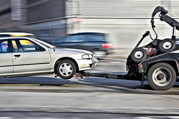 tow truck delivers the damaged vehicle