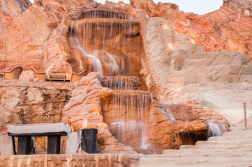 The waterfall on red rock in Egypt at summer