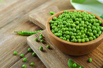 Fresh green peas in bowl on table close up