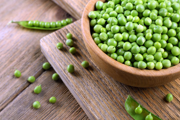 Fresh green peas in bowl on table close up