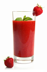 Glass of strawberry smoothie with berries isolated on white