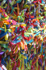 Fototapeta na wymiar Colorful Brazilian wish ribbons tied to a fence at the Bonfim Church Salvador Bahia Brazil 
