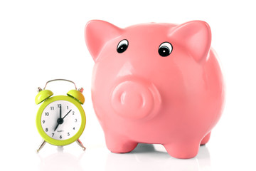 Piggy bank with alarm clock isolated on white