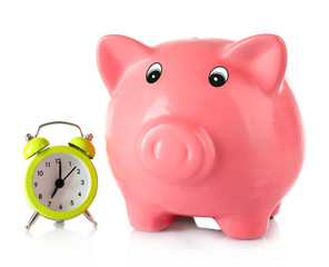 Piggy bank with alarm clock isolated on white