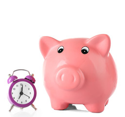 Piggy bank with alarm clock isolated on white