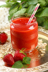 Strawberry smoothie on wooden table background