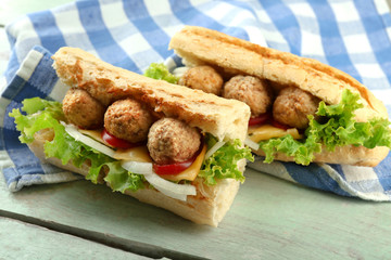 Homemade Spicy Meatball Sub Sandwich on wooden table background
