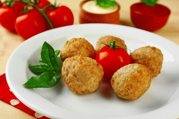 Meat balls on plate, on wooden table background