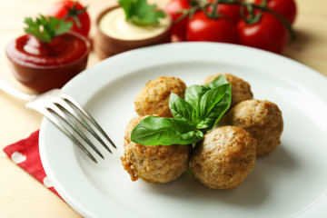 Meat balls on plate, on wooden table background