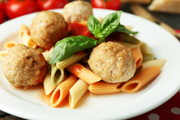 Pasta with meatballs on plate, on wooden  table background