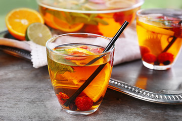 Fruity punch in glassware on metal tray, closeup
