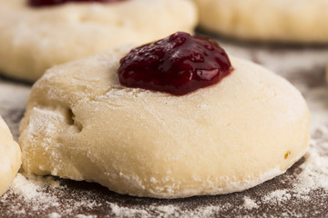 Dough with marmelade on wooden board
