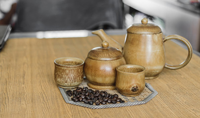 Soft focus image of coffee beans and coffee cups set on wooden b