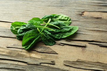 Fresh spinach leaves on wooden background