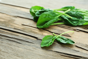 Fresh spinach leaves on wooden background