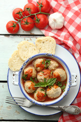 Meat balls with tomato sauce, on wooden background