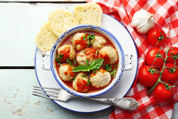 Meat balls with tomato sauce, on wooden background