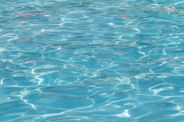 Fototapeta premium Blue pool water with sun reflections