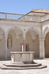Fototapeta premium Courtyard Benedictine Monastery at Monte Cassino, a stone fountain and arcades