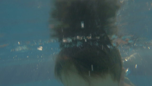 Boy Swimming on Father's Back