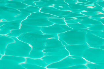 green pool water with sun reflections