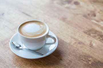 Coffee in white cup on wood table