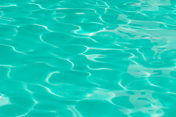 green pool water with sun reflections