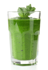 Glass of green vegetable juice with basil isolated on white