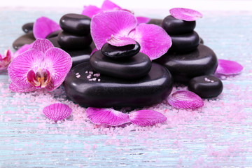 Fototapeta na wymiar Violet orchid and zen stones close-up