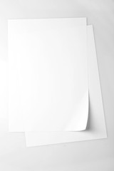 White sheets of paper on white background