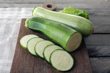 Fresh zucchini with squash on cutting board