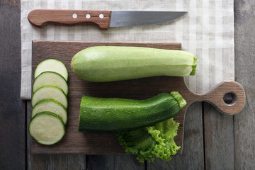 Fresh zucchini with squash on cutting board