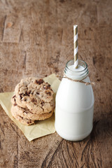 Fresh milk with drinking straw and cookies