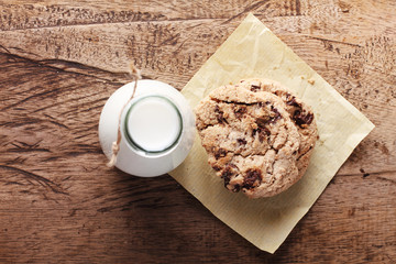 fresh milk and cookies on wooden background