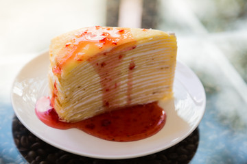 Crepe cake with strawberry sauce