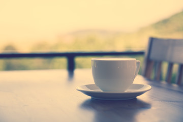 Coffee in white cup on wood table ( Filtered image processed vin