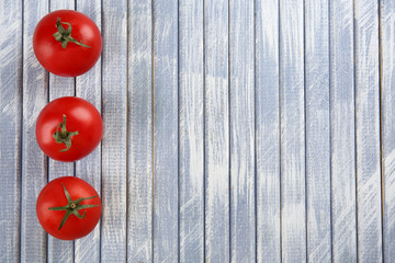 Fresh cherry tomatoes on wooden background