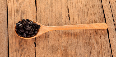 Coffee beans in wooden spoon