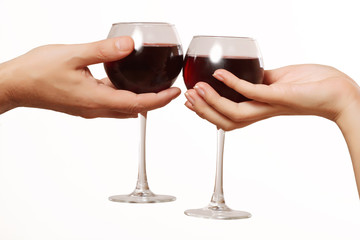 glasses of wine in a female and a male hand