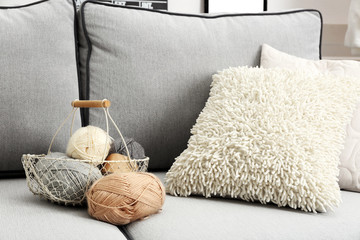 Knitting thread in basket  on living room interior background
