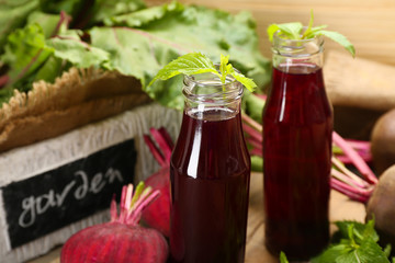 Fresh beet juice on wooden table, closeup