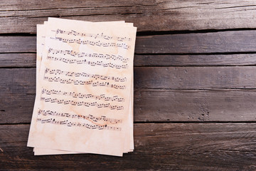 Fototapeta premium Music sheets on wooden background