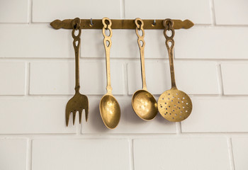 Vintage kitchen spoon  and fork hanging on wall ( Filtered image