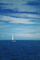 Fototapeta na wymiar Boat Sailing at Blue Sea