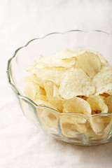 Delicious potato chips in bowl