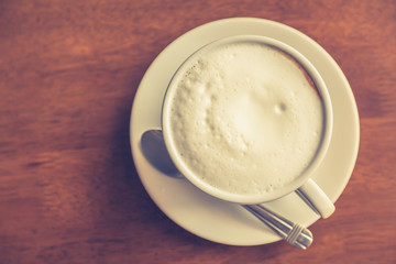 Hot latte art coffee on table ( Filtered image processed vintage