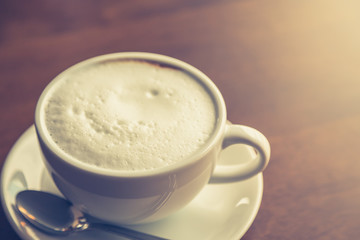 Hot latte art coffee on table ( Filtered image processed vintage